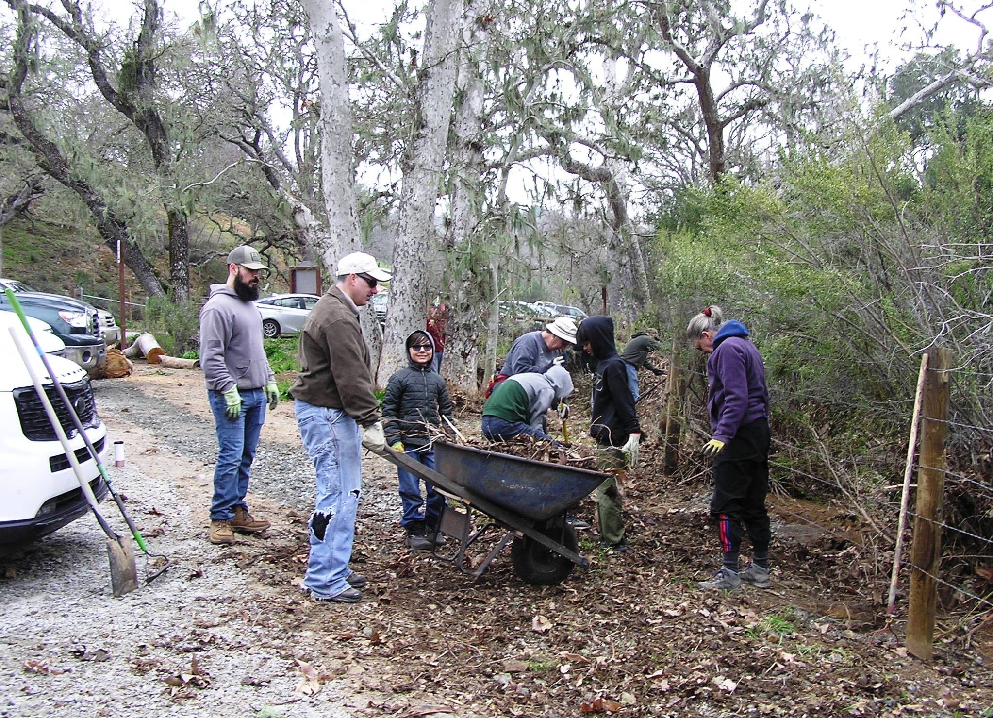 Cleaning debris off the fence . . . the creek flow was that high!